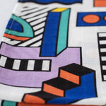 A close up of the pattern featured on the Etta Loves x Camille Walala Muslin Blanket.