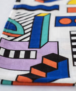 A close up of the pattern featured on the Etta Loves x Camille Walala Muslin Blanket.