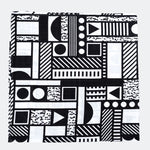 The Etta Loves x Camille Walala XL Muslin Square - Mono folded up into a square on a plain background. 