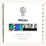 The Etta Loves x Camille Walala Muslin sensory squares shown in it's white box with brand name and logo the front. 