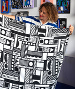 Camille Walala holding up an Etta Loves x Camille Walala XL Muslin Square - Mono