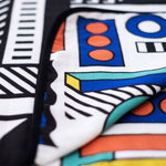 A close up of the coloured side of the Etta Loves x Camille Walala Muslin Blanket.