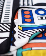 A close up of the coloured side of the Etta Loves x Camille Walala Muslin Blanket.