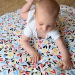 A closer look at the colourful Sycamore print on the Etta Loves Reversible Organic Cotton Baby Play Mat - Plant Print with black and white Ferns on the other side