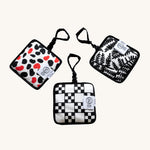 Etta Loves Organic Cotton Reversible Sensory Hanging Squares - 3 Pack, with exciting patterns on each side with some squares having a bell, crinkle paper or a mirror on the reverse side
