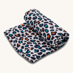The Etta Loves extra large organic cotton sensory muslin square, in an Orange Leopard print.