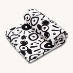Etta Loves Extra Large Organic Cotton Baby Muslin Square - Eyes. Made from GOTS Organic Cotton, with large black circle patterns on a cream background