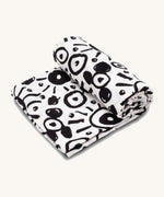 Etta Loves Extra Large Organic Cotton Baby Muslin Square - Eyes. Made from GOTS Organic Cotton, with large black circle patterns on a cream background