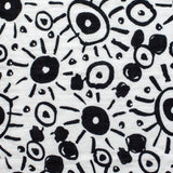 The Etta Loves Extra Large Organic Cotton Baby Muslin Squares tied to a wooden bamboo ladder in black leopard spots