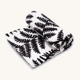 Etta Loves Extra Large Organic Cotton Baby Muslin Square - Fern, made from GOTS organic cotton with a black leafy fern print. On a cream background