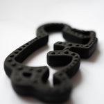 A close up of the Etta Loves X Keith Haring Natural Rubber Sensory Teether showing the detail on the outer rim