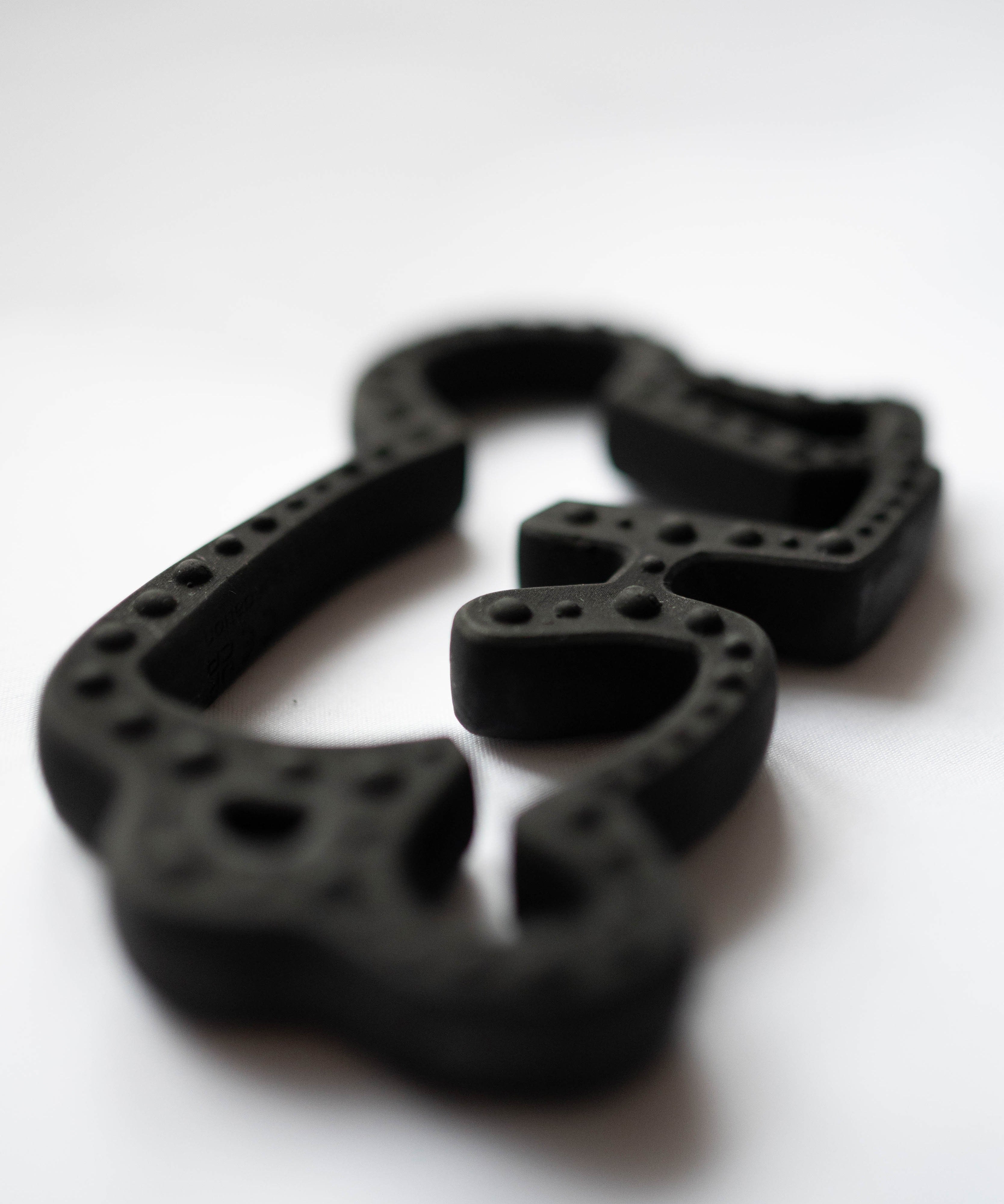 A close up of the Etta Loves X Keith Haring Natural Rubber Sensory Teether showing the detail on the outer rim