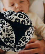 Etta Loves x Liberty organic cotton sensory grasping ball showing the Liberty pattern and black inner