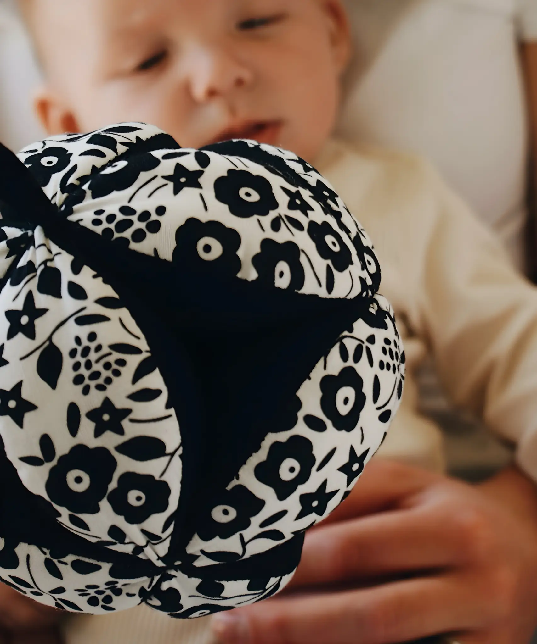 Etta Loves x Liberty organic cotton sensory grasping ball showing the Liberty pattern and black inner
