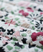 Etta Loves x Liberty organic cotton colourful playmat showing a close up of the repeating floral design 