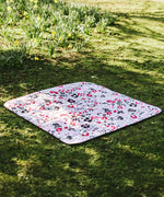Etta Loves x Liberty organic cotton colourful playmat laid on grass
