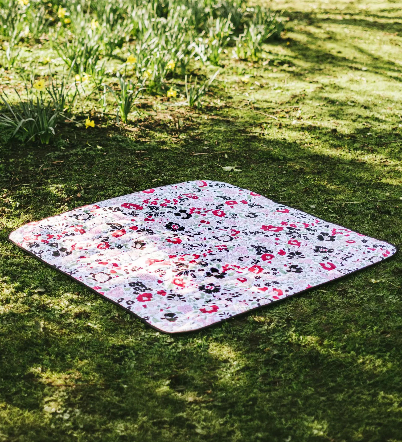 Etta Loves x Liberty organic cotton colourful playmat laid on grass