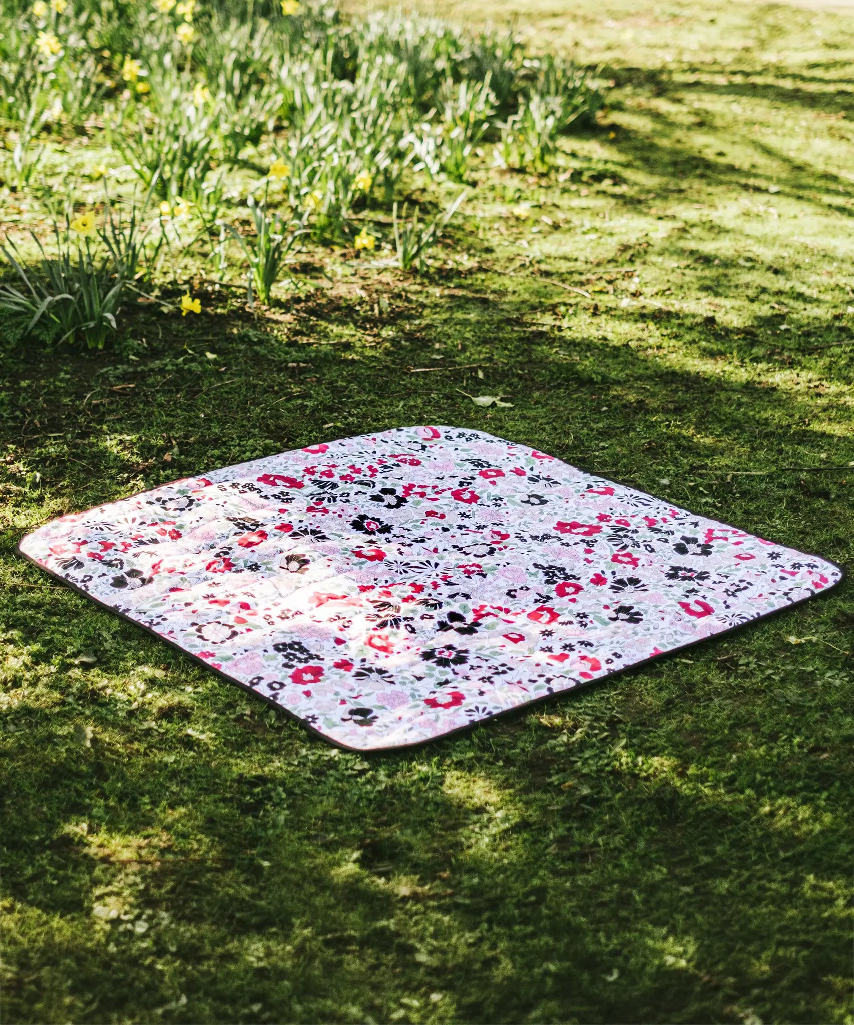 Etta Loves x Liberty organic cotton colourful playmat laid on grass