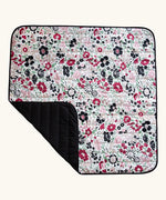 Etta Loves x Liberty organic cotton colourful sensory outdoor playmat showing a repeating floral design and a black reverse panel