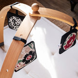 Set of 3 Etta Loves x Liberty sensory hanging squares hanging on a wooden baby gym
