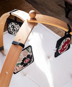 Set of 3 Etta Loves x Liberty sensory hanging squares hanging on a wooden baby gym