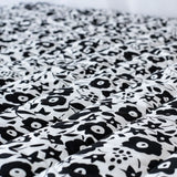 Etta Loves x Liberty organic cotton monochrome sensory playmat showing close up of the repeating floral design 