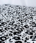 Etta Loves x Liberty organic cotton monochrome sensory playmat showing close up of the repeating floral design 