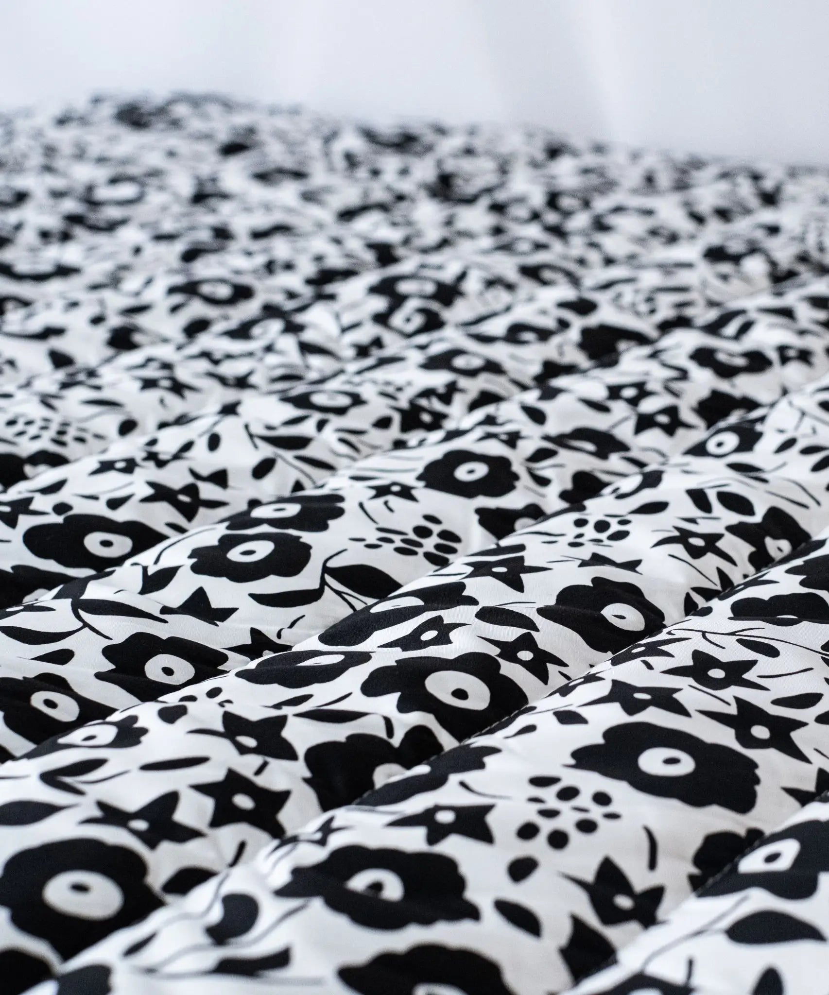 Etta Loves x Liberty organic cotton monochrome sensory playmat showing close up of the repeating floral design 