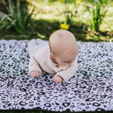 Baby crawling on the Etta Loves x Liberty organic cotton monochrome sensory playmat 