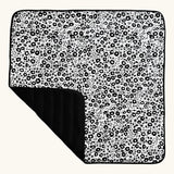Etta Loves x Liberty organic cotton monochrome sensory outdoor playmat showing a repeating floral design and a black reverse panel
