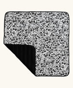 Etta Loves x Liberty organic cotton monochrome sensory outdoor playmat showing a repeating floral design and a black reverse panel