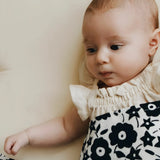 Etta Loves x Liberty organic cotton muslin square wrapped around a baby