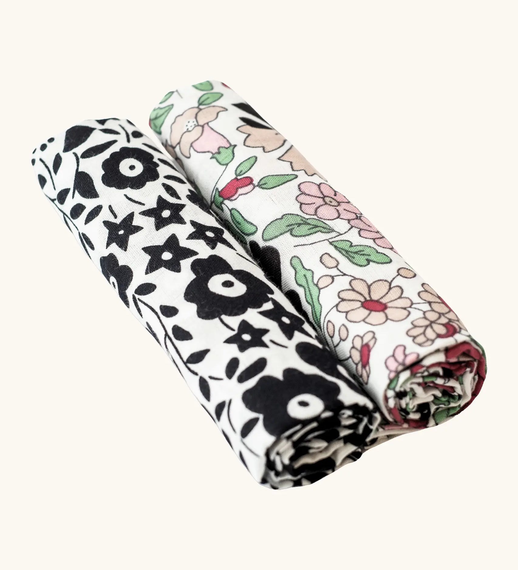 Etta Loves x Liberty muslin squares - 2 Pack. With a monochromatic floral pattern on the left cloth, and a pastel floral design on the right cloth.
