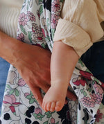Mother holding the pastel floral Etta Loves x Liberty muslin square cloth 