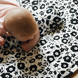 GOTS organic cotton reversible sensory playmat from Etta Loves in collaboration with Liberty showing Fairford shadow design with baby crawling on top

