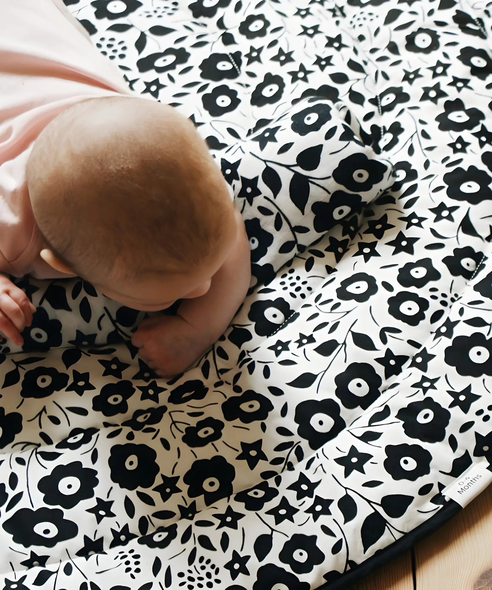 GOTS organic cotton reversible sensory playmat from Etta Loves in collaboration with Liberty showing Fairford shadow design with baby crawling on top

