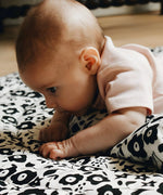 Baby having tummy time on the Etta Loves reversible sensory playmat in collaboration with showing the Fairford shadow design