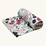 Etta Loves x Liberty organic cotton XL muslin swaddle blanket with a repeating pastel floral design for 5+ months