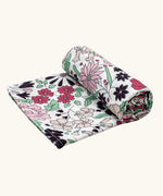 Etta Loves x Liberty organic cotton XL muslin swaddle blanket with a repeating pastel floral design for 5+ months