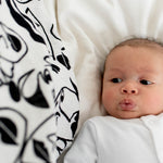 A baby looking up at the Lines print from the Etta Loves Organic Cotton Baby Muslin Squares 3 Pack - Drawing Print