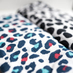 A closeup of the Etta Loves organic cotton muslin squares, in dalmatian and leopard prints. 
