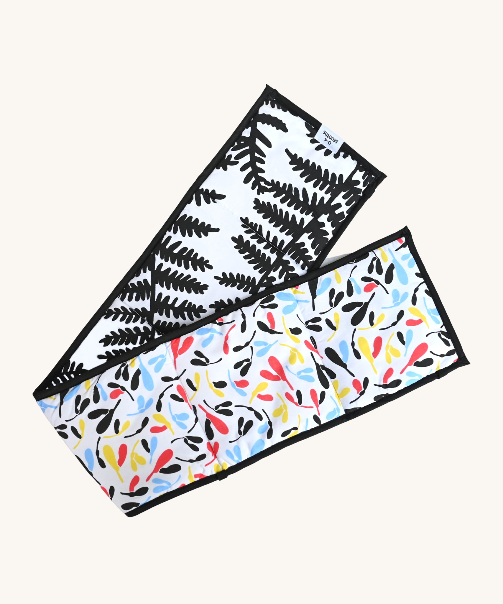 Etta Loves Organic Cotton Reversible Sensory Strip - Plant Print, with a colourful Sycamore print on one side, and a striking and bold black fern print on the other