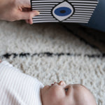 A close up of a parent playing with their child, using the Etta Loves Sensory Positive Affirmation Flash Cards