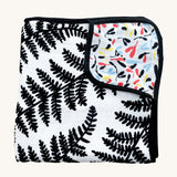 Etta Loves Reversible Organic Cotton Muslin Blanket - Plant Print with black and white Ferns on one side, and colourful Sycamore seeds print on the other