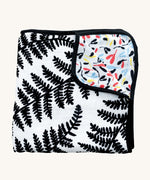 Etta Loves Reversible Organic Cotton Muslin Blanket - Plant Print with black and white Ferns on one side, and colourful Sycamore seeds print on the other