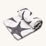 Etta Loves XL Organic Muslin Square. White fabric muslin cloth with black starfish on a cream background