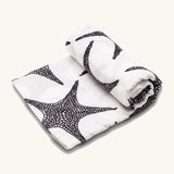 Etta Loves XL Organic Muslin Square. White fabric muslin cloth with black starfish on a cream background