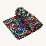 Etta Loves X Keith Haring Extra Large Organic Cotton Baby Muslin Square - Brazil, with strong, colourful shaped print 