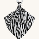Etta Loves Organic Zebra Comforter in Zebra Print. A soft and cuddly Zebra Print comforter in black and white stripes, a knotted top and two soft zebra ears on a cream background