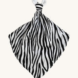 Etta Loves Organic Zebra Comforter in Zebra Print. A soft and cuddly Zebra Print comforter in black and white stripes, a knotted top and two soft zebra ears on a cream background